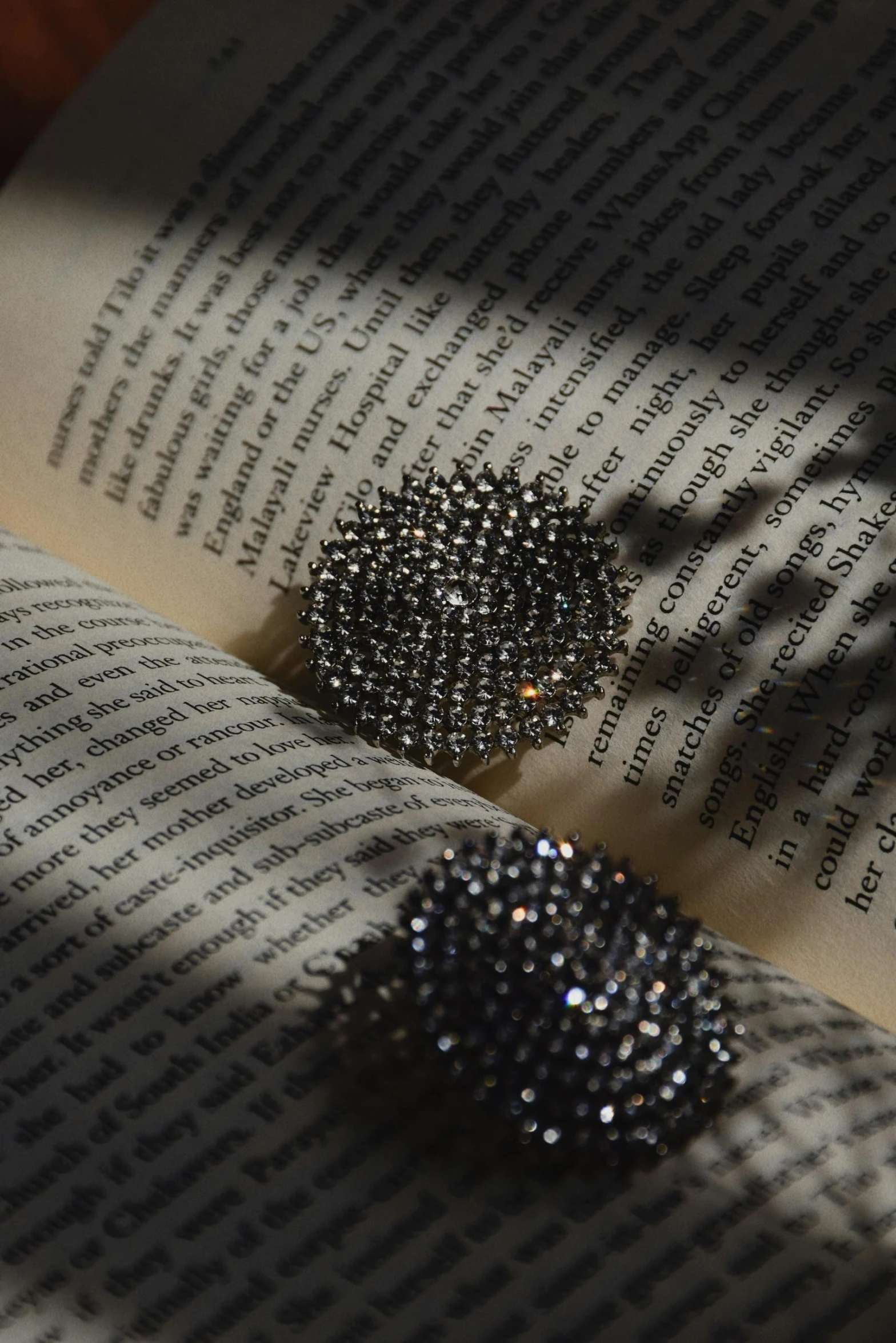 two books with some black crystals laying on them