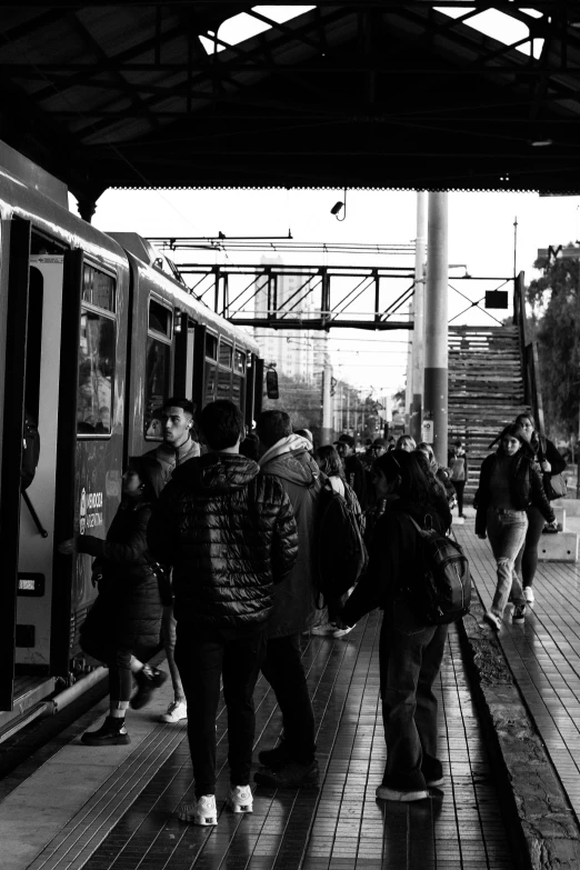 a group of people waiting on a train platform