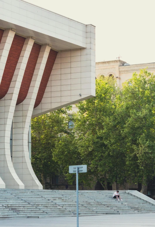 people walking in front of a building on a sidewalk