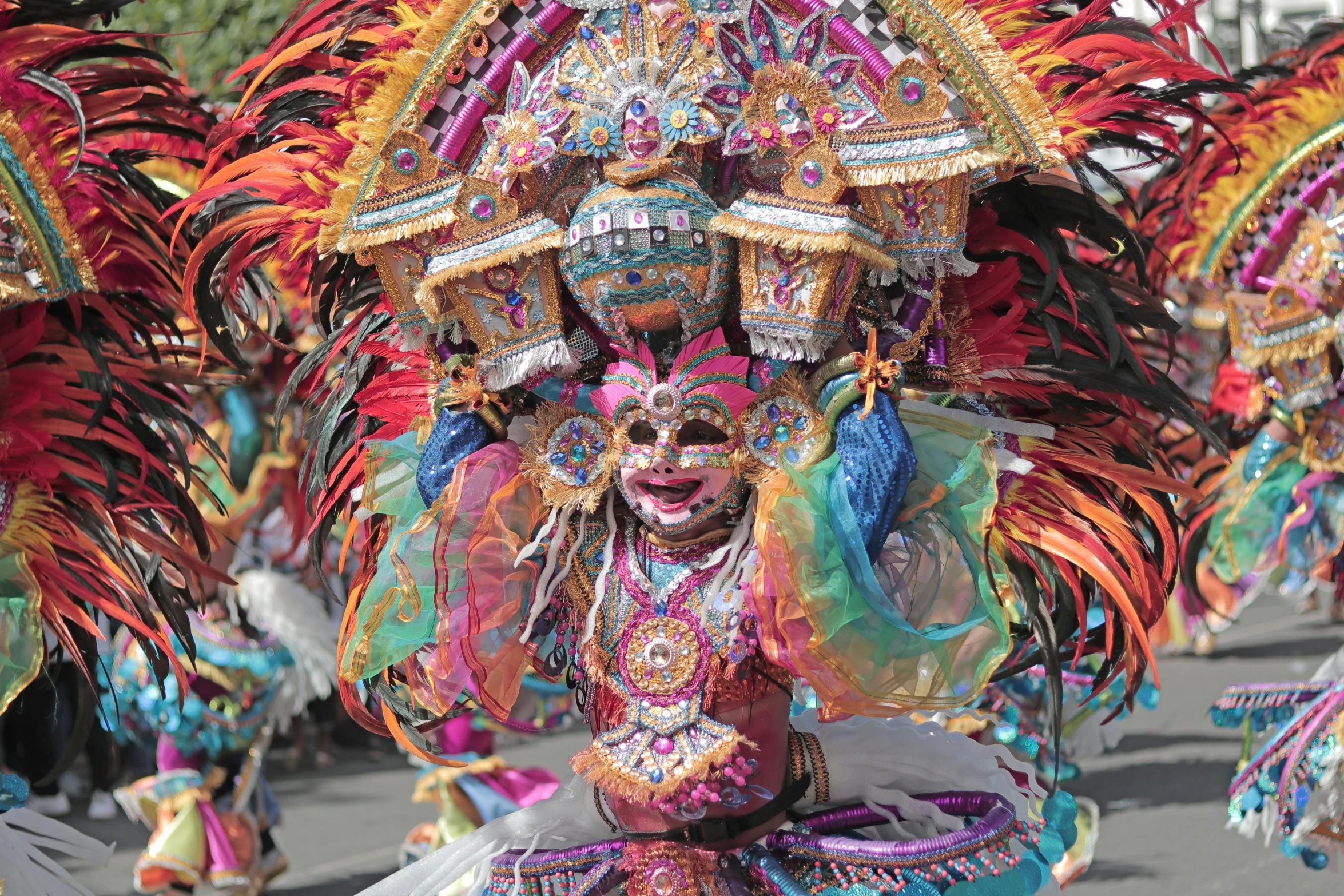 a colorful parade, with feathers and masks