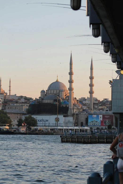 a view from across the water of the buildings and domes of a city in the background