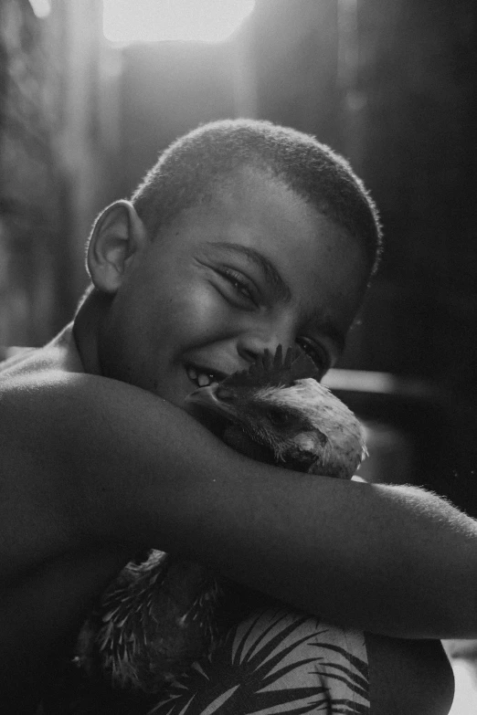 a man sitting down with his arm around a cat