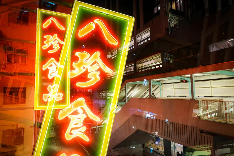 neon lit signs in front of a building