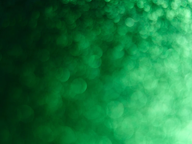 an abstract pograph of many green bubbles on the side