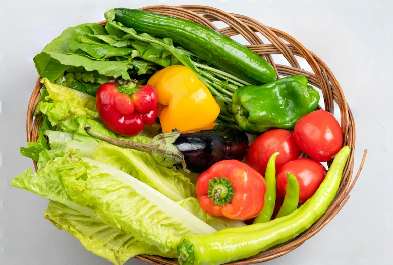 a wicker basket with many different types of vegetables