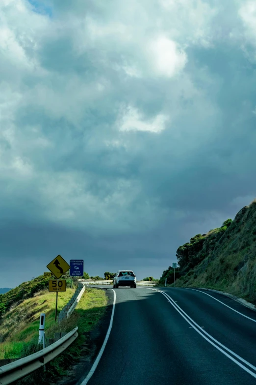 a truck on the road in front of a big mountain