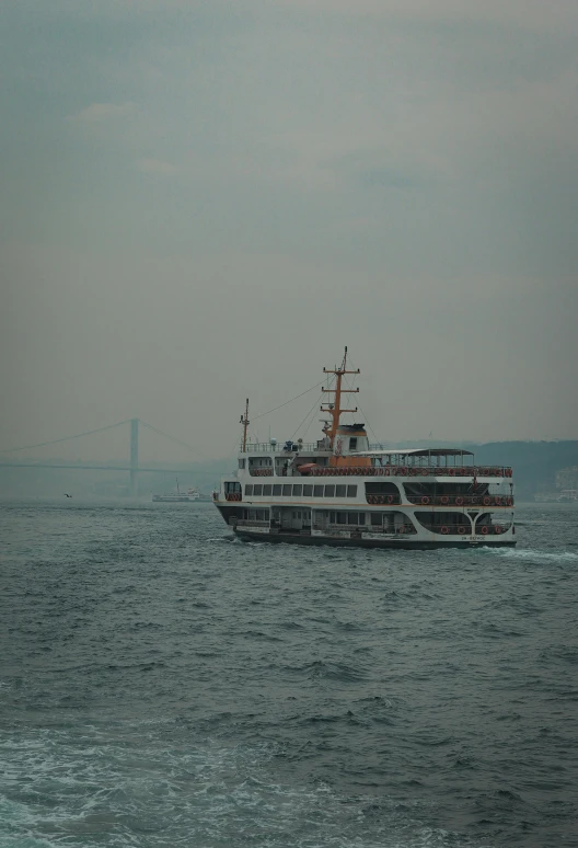 a ship is traveling down the water on a hazy day