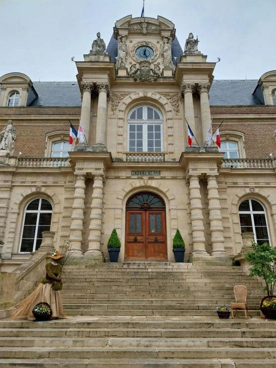 a large stone building with stairs leading to the front entrance