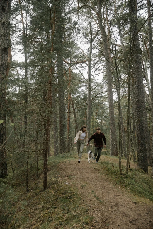 two men walking on a path in the woods