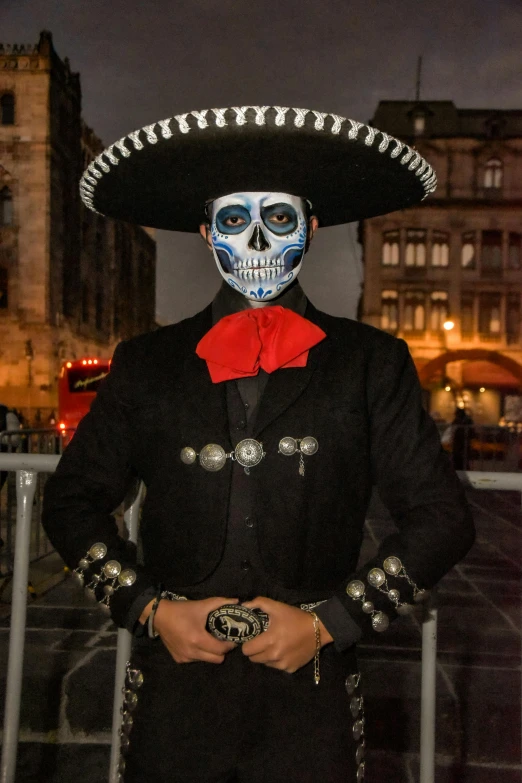 a man wearing skeleton makeup and a sombrero