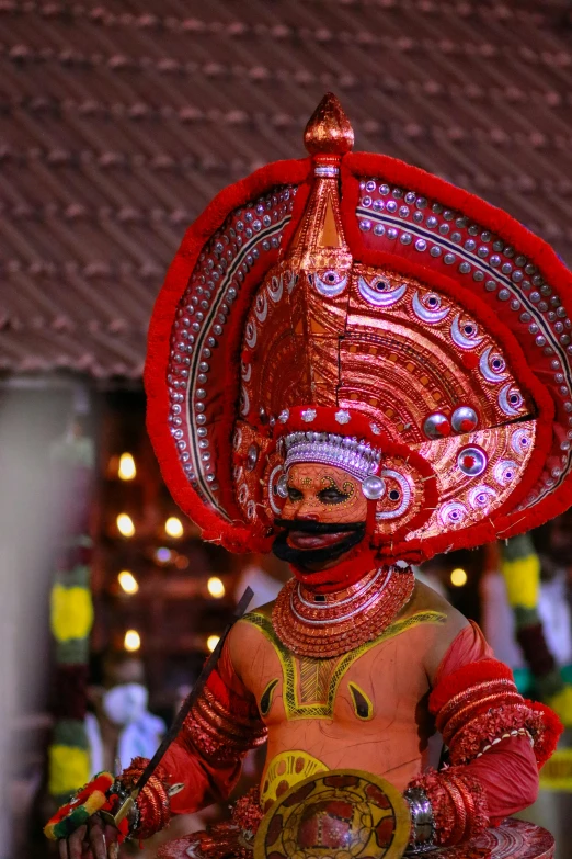 a man in costume with a head piece wearing a smile