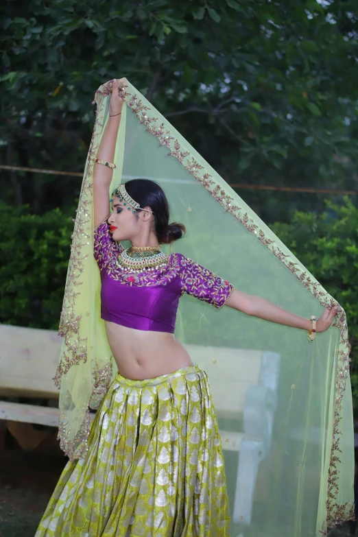 woman in green and yellow saree dancing