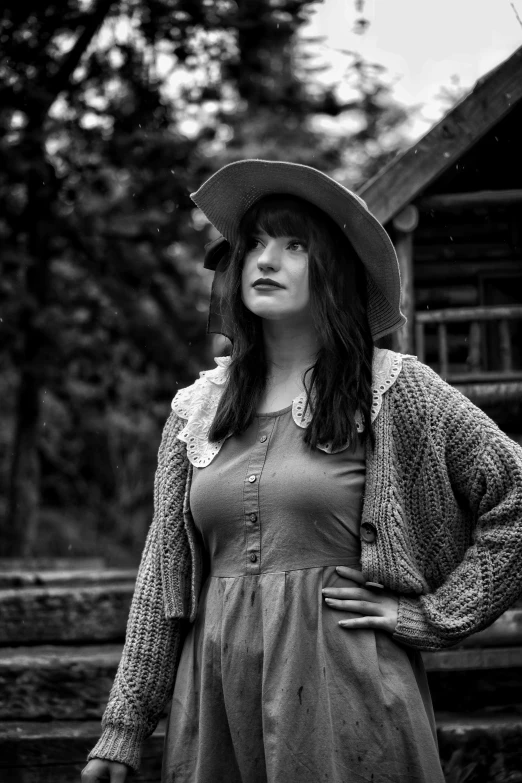 a beautiful woman standing next to a tree