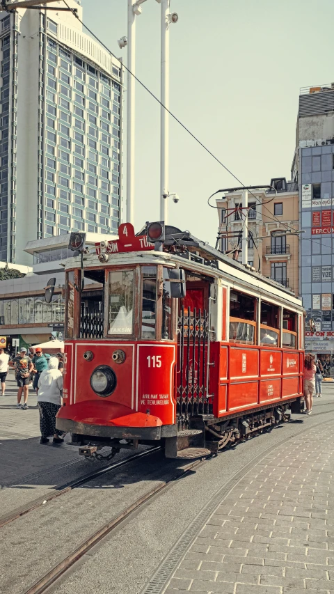 a red and white train car on tracks