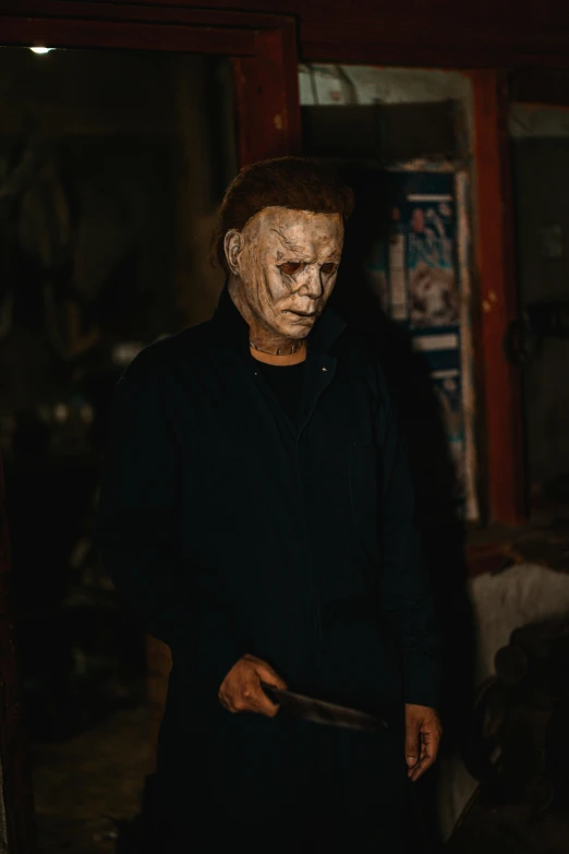 a man in creepy mask holding a knife