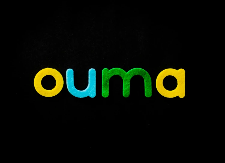 the word ouma is displayed in black and blue