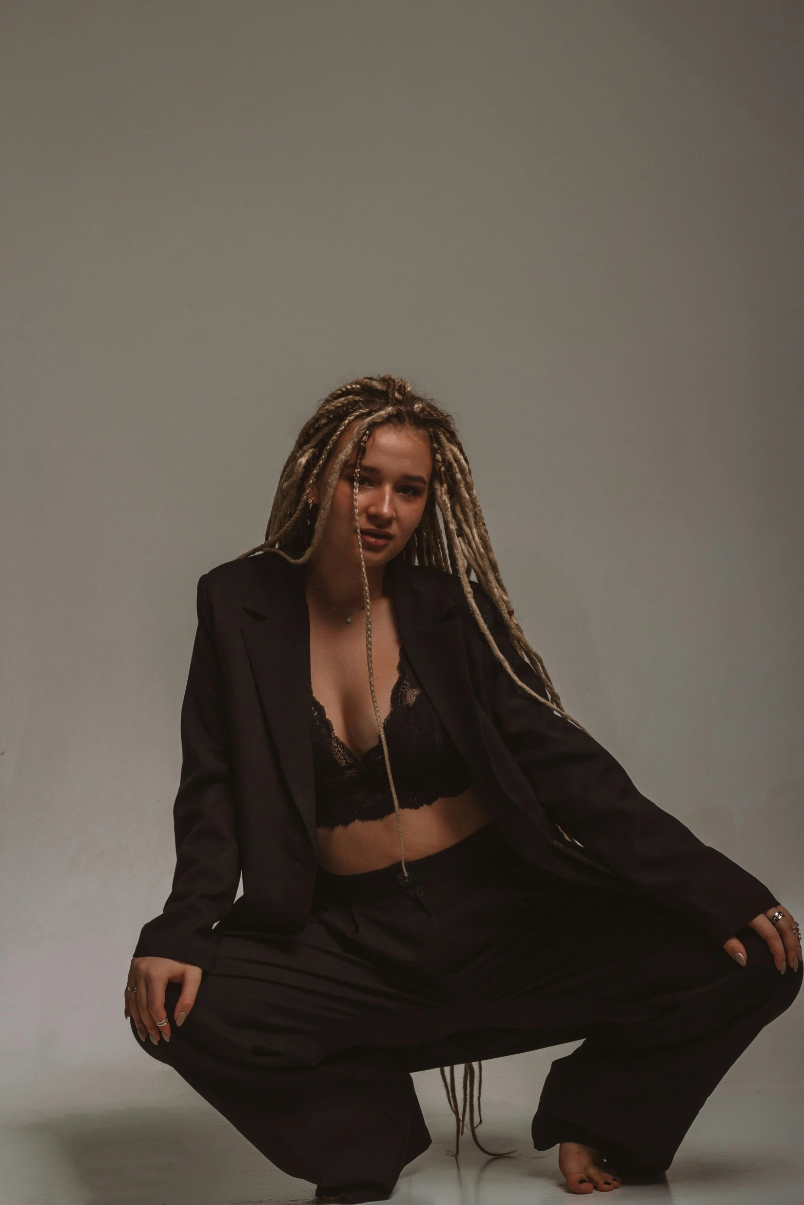 a woman with very long hair sitting on the ground