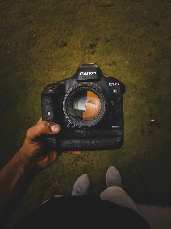 a camera is shown with an orange lens in the front