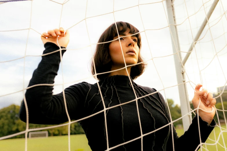 a woman is putting her arm around the goal