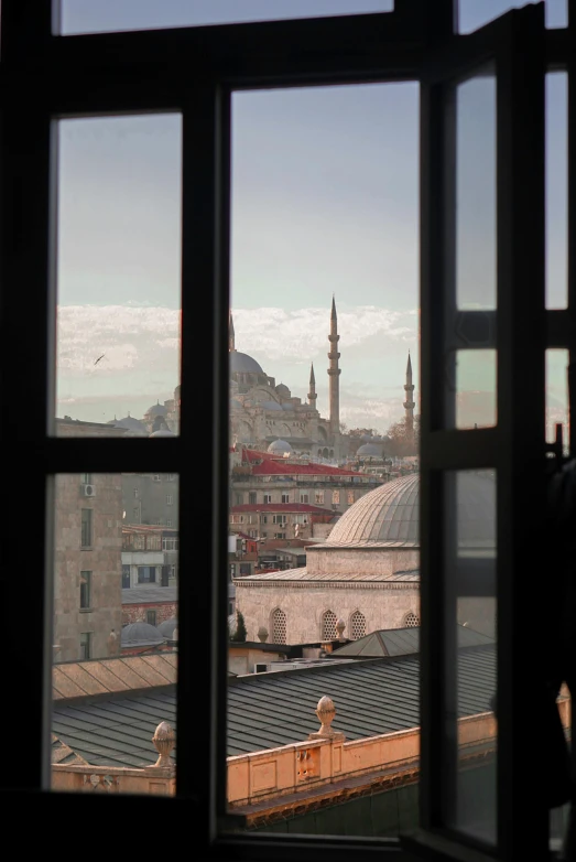 a city view from the window of an apartment building