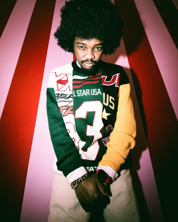 an african american man with a beard wearing sweater