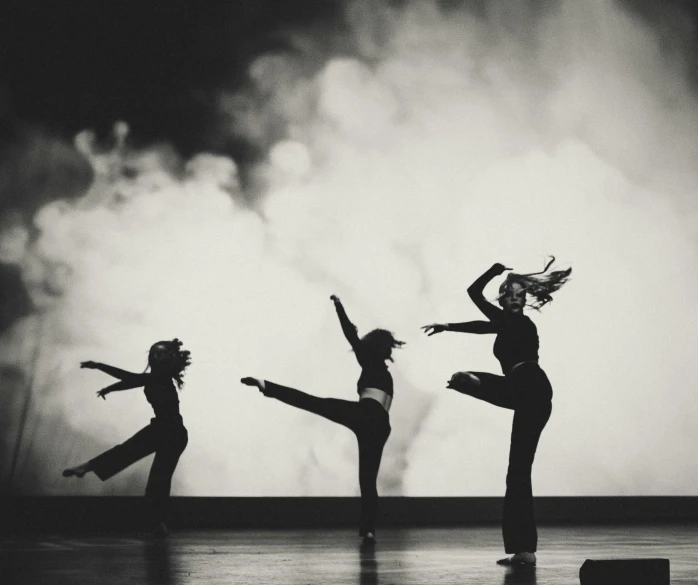 black and white po of four dancing girls