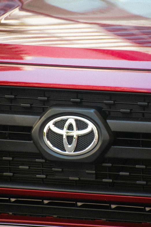 the emblem on the front of a red suv