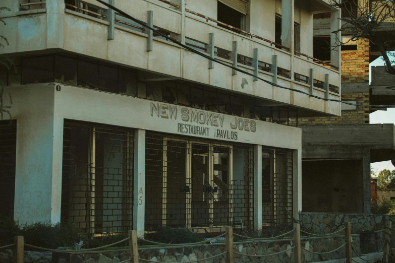 a large building with many windows that have a sign hanging above them