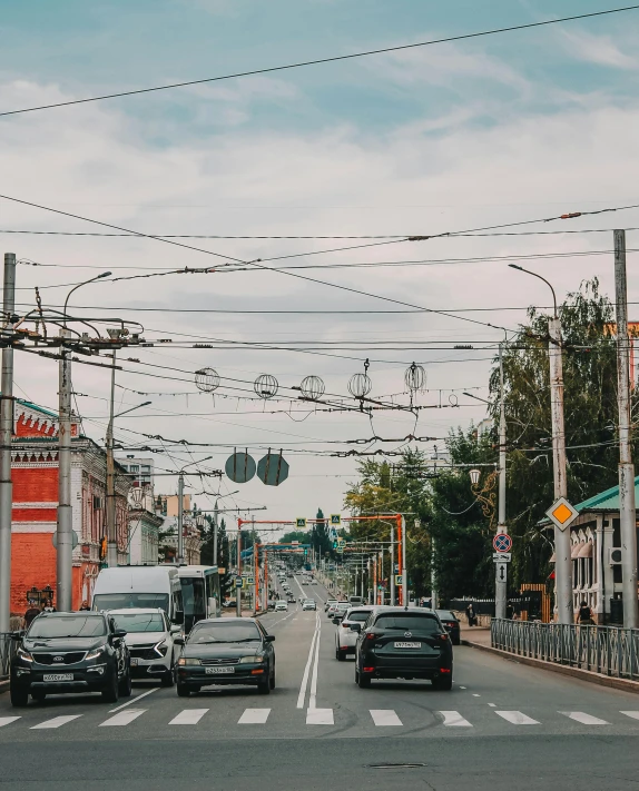 cars driving down the road on an overcast day