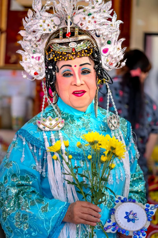 a woman wearing a costume that has yellow flowers in it