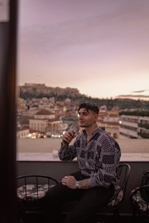 a man sitting at a table with a bottle in his hand