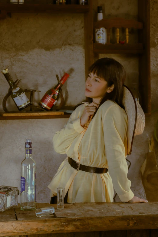 an asian girl in a yellow long - sleeved outfit sits at a desk