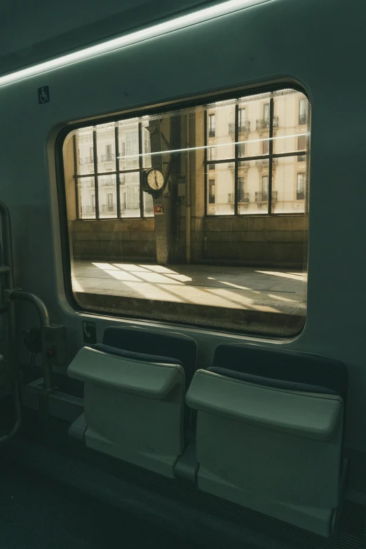 a window inside of a train looking into another room