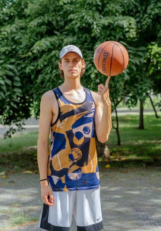 man wearing a basketball jersey and holding a basketball