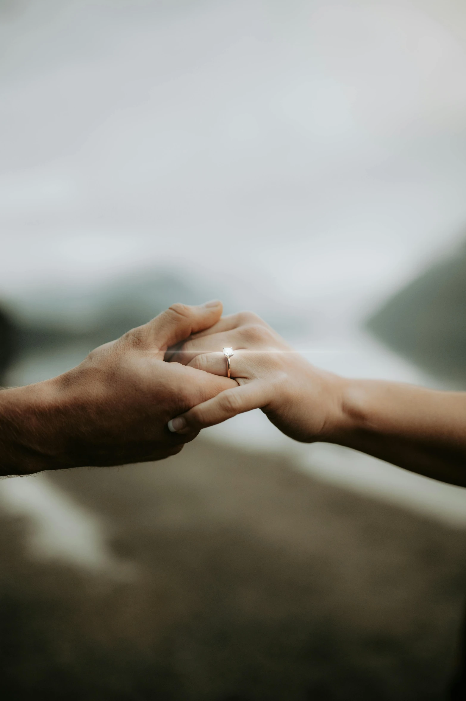 a woman and a man holding hands on a road