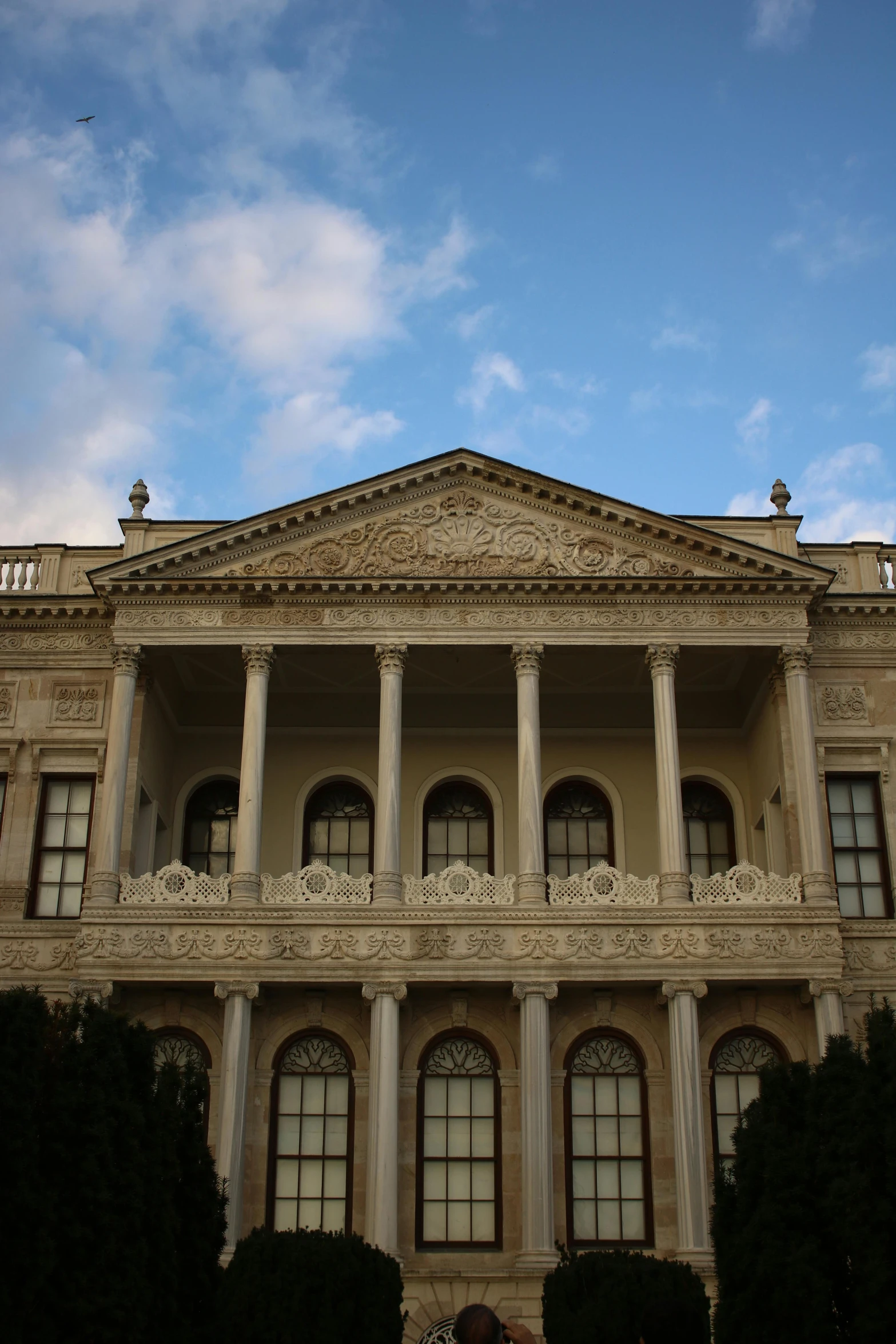 a large building with columns and an upper deck