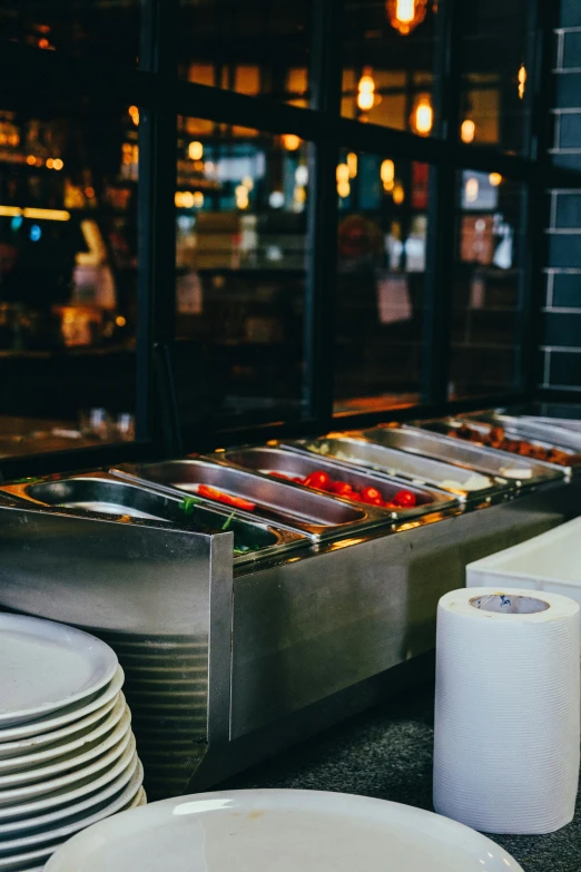 stacks of plates are scattered in front of the buffet