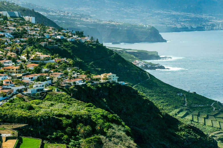 a small town in the middle of a lush green hillside