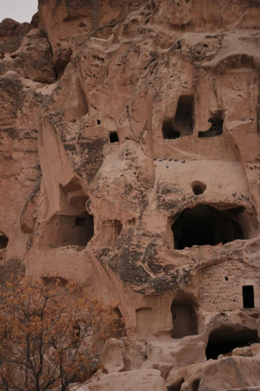 a building made out of natural rock with small holes