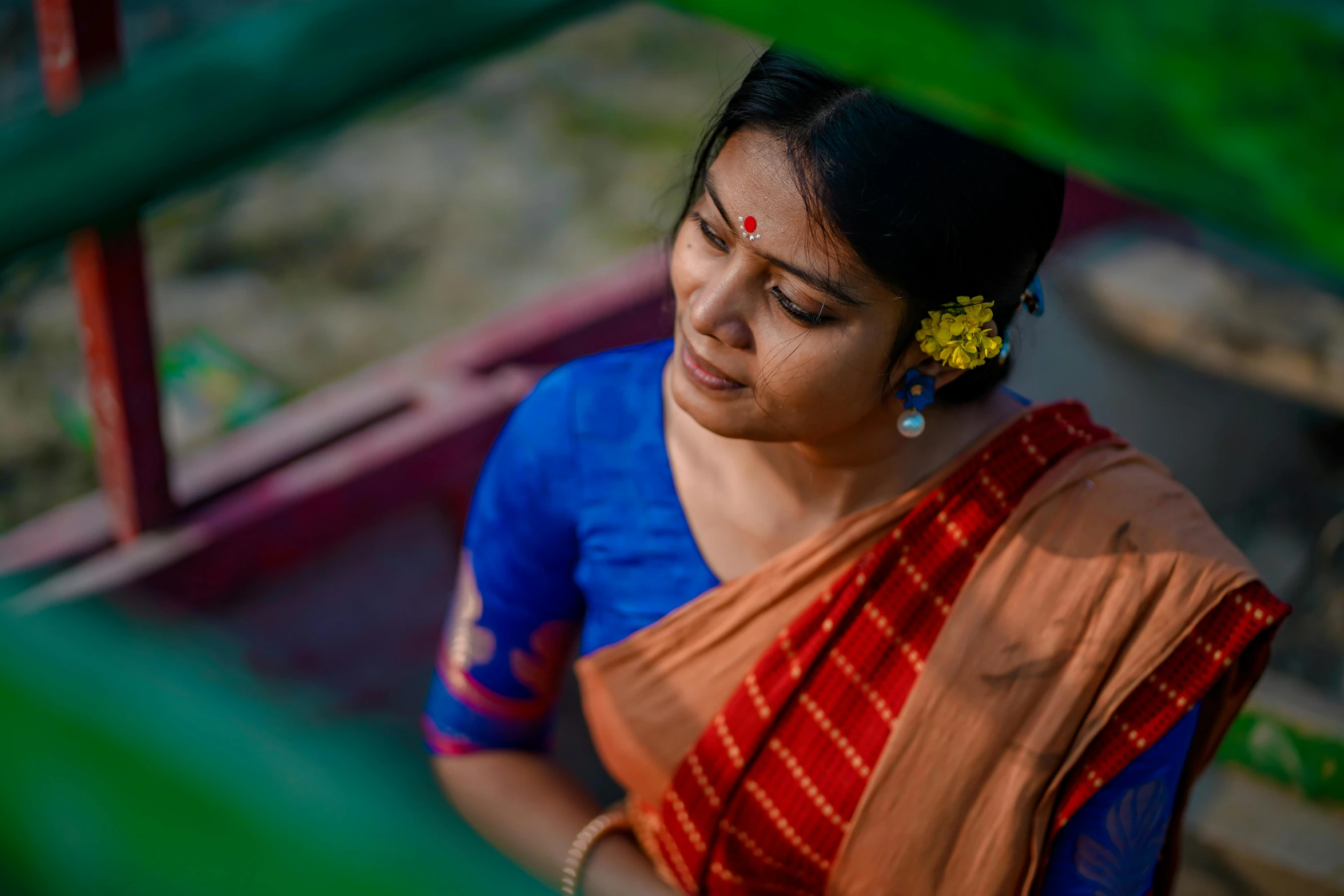 the woman is wearing blue and orange sari