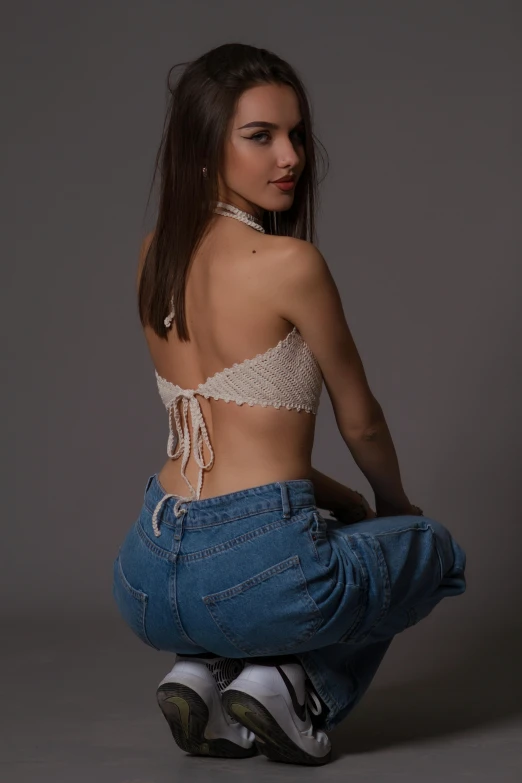 woman sitting on top of jean shorts posing for a po