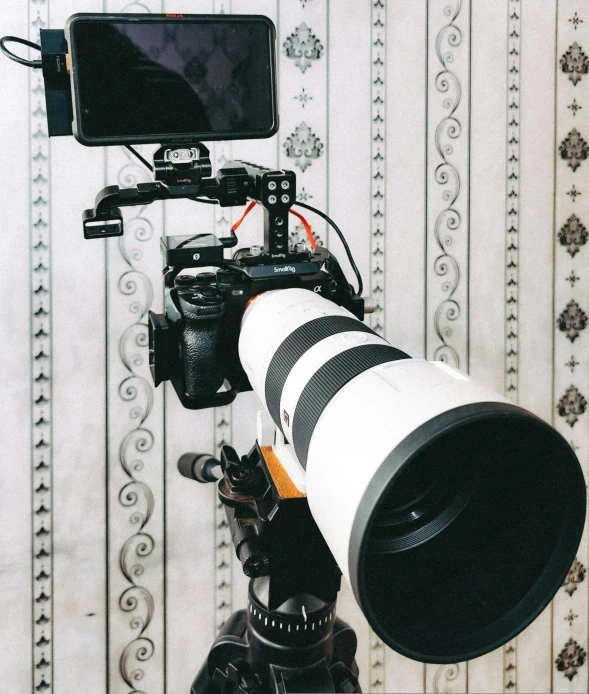 a large lens is hooked up to a camera set