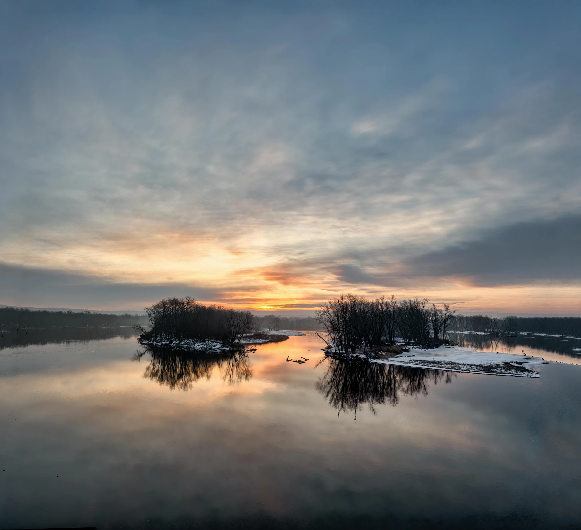 sunrise with small boats in the water and overcast sky