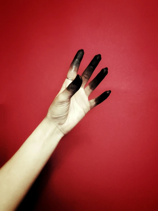 a hand with multiple black spots over it