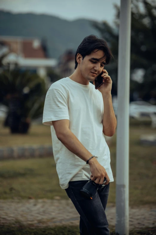 a man talking on a cellphone in a park