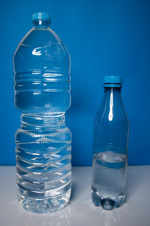 a bottle and jug of water are sitting beside each other