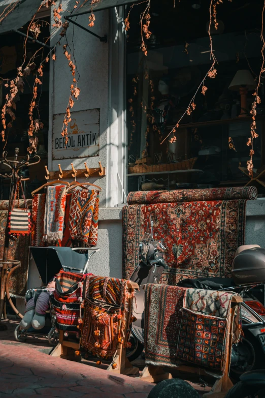 several fabrics on display near a shop