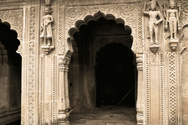 the interior of an ornate indian palace has statues on either side of it