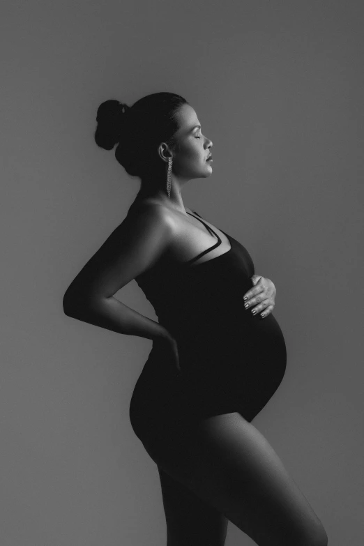 a pregnant woman poses in her full body