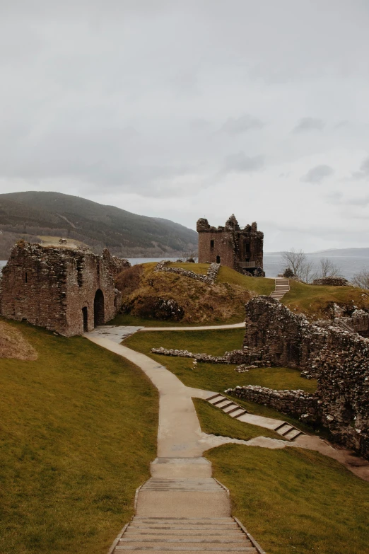 a pathway that is near a castle by some grass